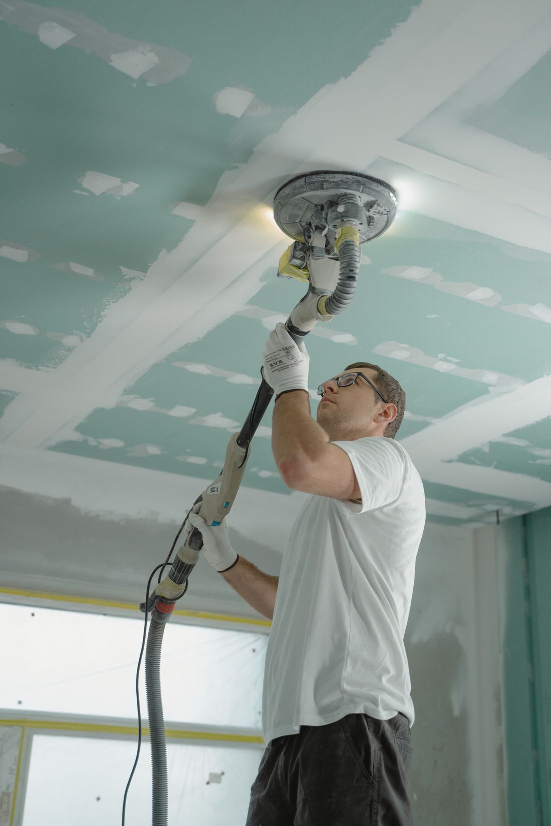 Sanding and finishing drywall during a home repair