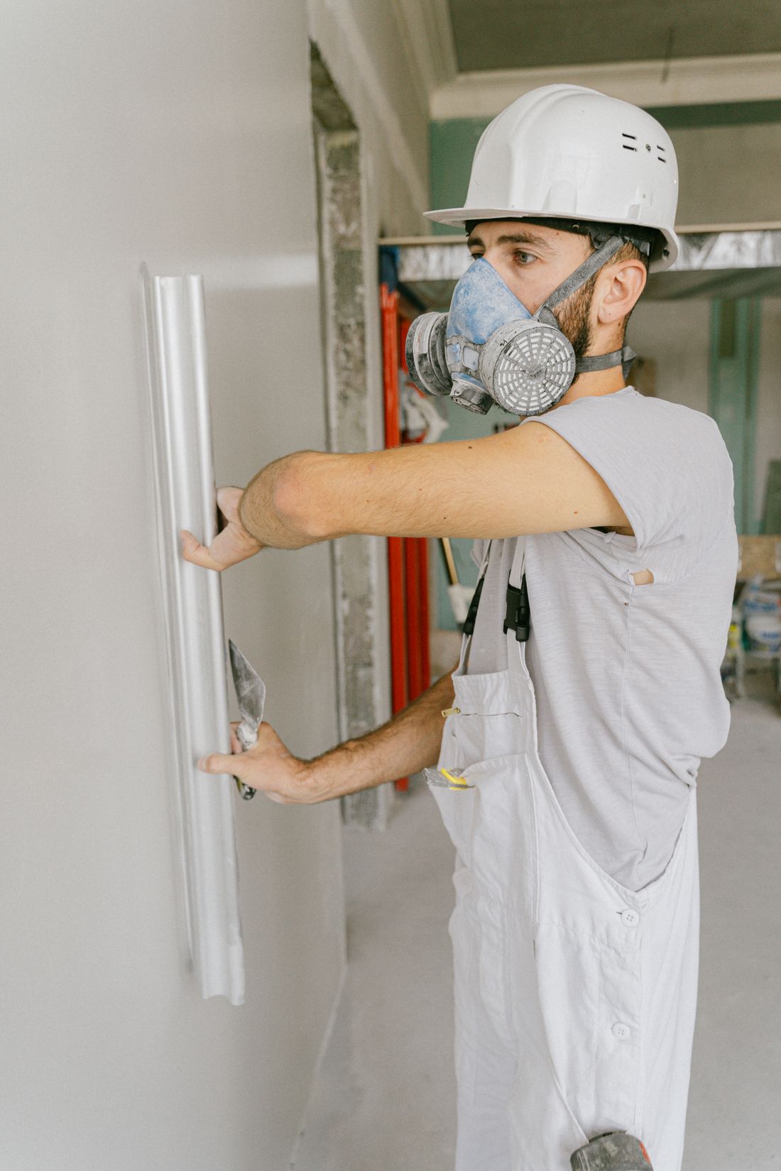 Contractor smoothing drywall compound during an interior repair