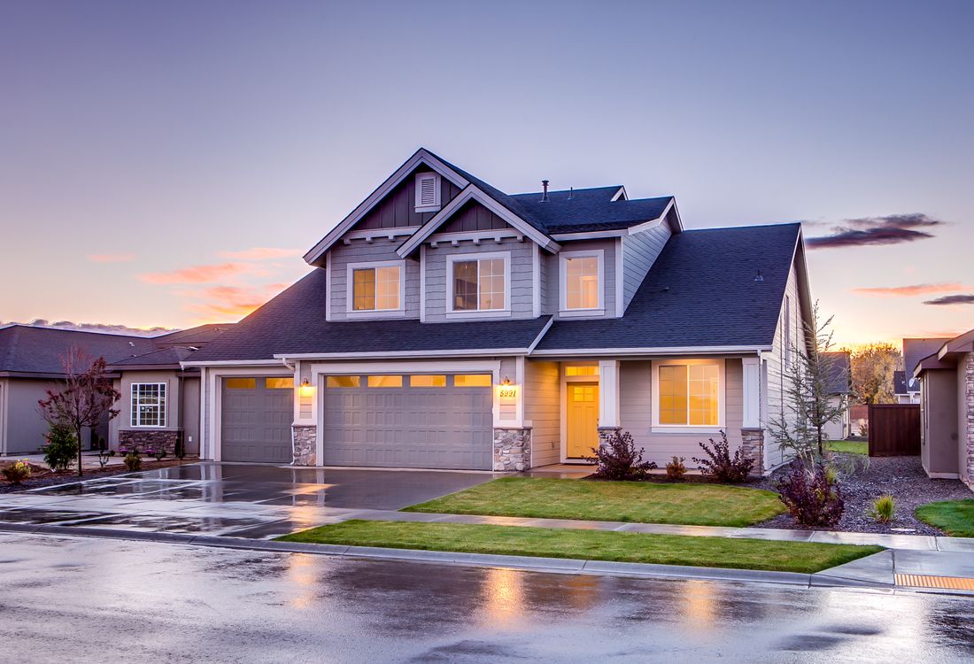 Well-maintained home with a manicured lawn at golden hour