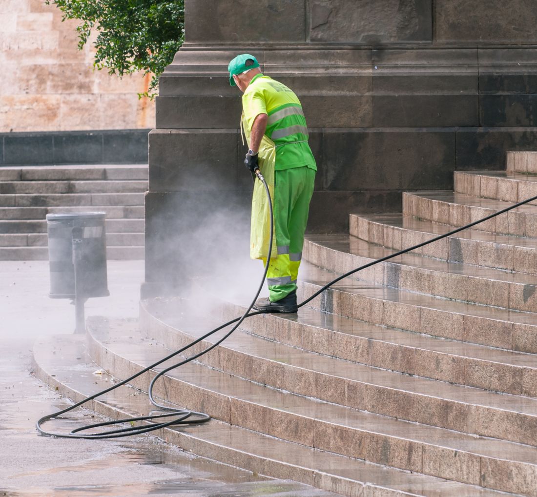 Pressure washing a home exterior surface