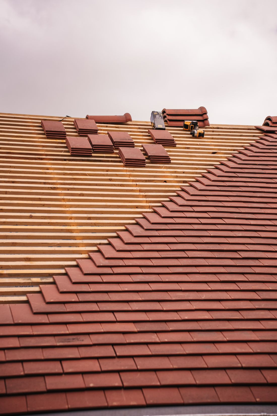 Roofer treating a roof to remove moss